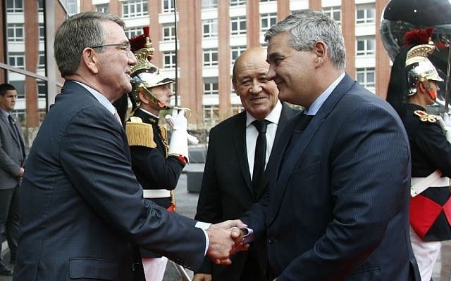 US Defense Secretary Ash Carter, left, and French Defense Minister Jean-Yves Le Drian, center, greet Belgian Defense Minister Steven Vandeput, right, upon arrival for a meeting by the dozen members of the US-led coalition fighting Islamic State in Iraq and Syria, in Paris, Tuesday, Oct. 25, 2016. (Charles Platiau/Pool photo via AP)