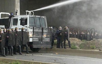In this screen grab taken from video, French police spray protesters using a water cannon during a demonstration in Calais, France, Saturday, Oct. 1, 2016. (AP)