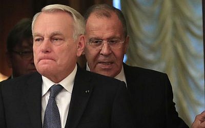 In this Oct. 6, 2016 file photo, Russian Foreign Minister Sergey Lavrov, right, meets with French Foreign Minister Jean-Marc Ayrault in Moscow. Ayrault, speaking on Monday, Oct. 10, 2016, called on the International Criminal Court to investigate Russia for possible war crimes in Syria. (AP Photo/Pavel Golovkin, File)