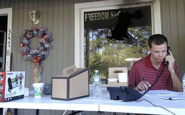 Blake Halsey, a 21-year-old college student and volunteer at the Orange County GOP office, takes a phone call from someone offering to volunteer on Monday, Oct. 17, 2016 in Hillsborough, North Carolina. (AP Photo/Jonathan Drew) Blake Halsey, a 21-year-old college student and volunteer at the Orange County GOP office, takes a phone call from someone offering to volunteer on Monday, Oct. 17, 2016 in Hillsborough, North Carolina. (AP Photo/Jonathan Drew)