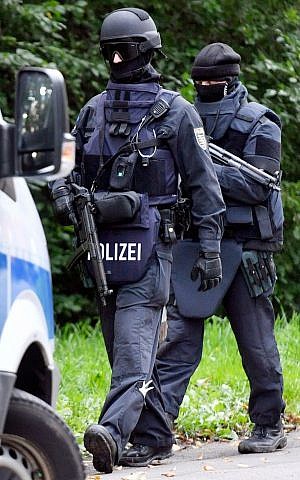 Police walk near an apartment building in the Yorck area of Chemnitz, eastern Germany, October 9, 2016. (Hendrik Schmidt/dpa via AP)