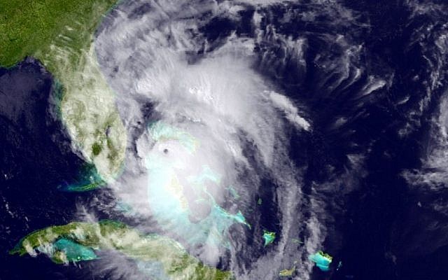 This GOES East satellite image posted at 5:12 p.m. and provided by the National Oceanic and Atmospheric Administration (NOAA), shows Hurricane Matthew moving northwest along the east coast of Florida, Thursday, Oct. 6, 2016. (NOAA via AP)
