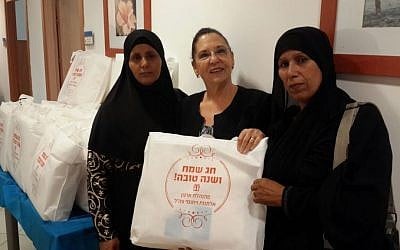 Chairperson of the IDF Widows and Orphans Organization, Tami Shelach, hands out gifts to Bedouin Muslim widows in southern Israel on September 28, 2016. (IDFWO)