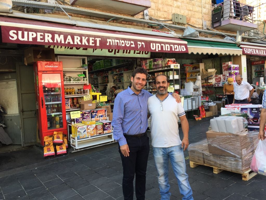 Jerusalem deputy mayor Ofer Berkovitch and Mahane Yehuda market chairman Nino Peretz, standing outside Peretz's store on the open street of the market (Jessica Steinberg/Times of Israel) Jerusalem deputy mayor Ofer Berkovitch and Mahane Yehuda market chairman Nino Peretz, standing outside Peretz's store on the open street of the market (Jessica Steinberg/Times of Israel)