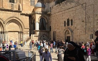 Visitors outside the Church of the Holy Sepulchre in Jerusalem, October 28, 2016. The Immovable Ladder is seen at top left (Times of Israel staff) Visitors outside the Church of the Holy Sepulchre in Jerusalem, October 28, 2016. The Immovable Ladder is seen at top left (Times of Israel staff)