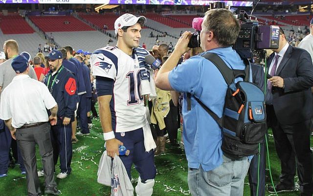 A reporter uses LiveU technology at the Super Bowl in 2015 (Courtesy)