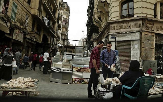 In this Tuesday, Oct. 18, 2016 photo, a woman sells bread near the Tawfiqia market in downtown Cairo, Egypt. (AP Photo/Nariman El-Mofty, File) In this Tuesday, Oct. 18, 2016 photo, a woman sells bread near the Tawfiqia market in downtown Cairo, Egypt. (AP Photo/Nariman El-Mofty, File)