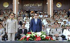 In this July 22, 2015, file photo, provided by the office of the Egyptian Presidency, Egyptian President Abdel-Fattah el-Sissi, center, and Defense Minister Sedqi Sobh, left, stand at attention at the Air Defense Academy in Alexandria, Egypt. (Mohammed Samaha/Egyptian Presidency via AP, File)