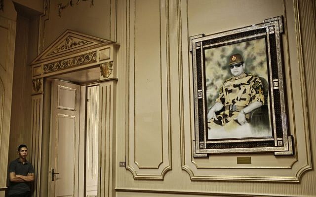 In this Monday, Oct. 10, 2016 file photo, an Egyptian museum worker looks at a portrait of Egyptian President Abdel-Fattah el-Sissi inside the Presidential Gifts Hall in Abdeen Palace, one of downtown Cairo's historic palaces. (AP Photo/Nariman El-Mofty, File) In this Monday, Oct. 10, 2016 file photo, an Egyptian museum worker looks at a portrait of Egyptian President Abdel-Fattah el-Sissi inside the Presidential Gifts Hall in Abdeen Palace, one of downtown Cairo's historic palaces. (AP Photo/Nariman El-Mofty, File)