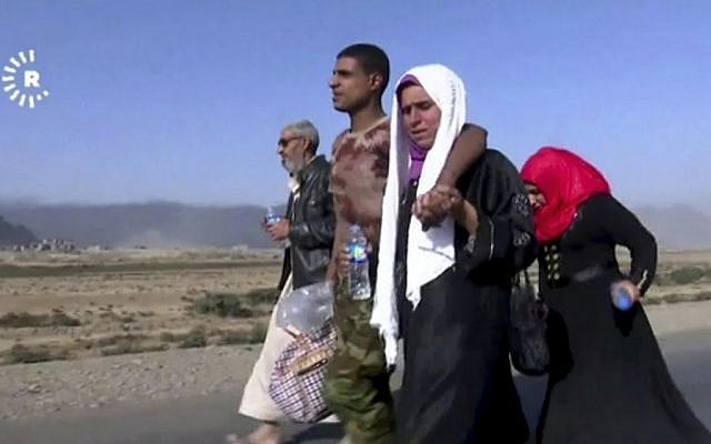 Screen capture from a video showing a family fleeing Mosul, Iraq,Tuesday, Oct. 18, 2016. (Rudaw News Agency via AP) Screen capture from a video showing a family fleeing Mosul, Iraq,Tuesday, Oct. 18, 2016. (Rudaw News Agency via AP)