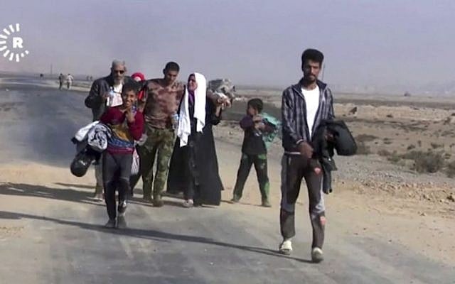 Screen capture from a video showing a family fleeing Mosul, Iraq, October 18, 2016. (Rudaw News Agency via AP) Screen capture from a video showing a family fleeing Mosul, Iraq, October 18, 2016. (Rudaw News Agency via AP)