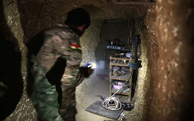 A peshmerga fighter walks through the kitchen of an underground tunnel made by Islamic State fighters, Tuesday, October 18, 2016, near Mosul. (AP/Bram Janssen) A peshmerga fighter walks through the kitchen of an underground tunnel made by Islamic State fighters, Tuesday, October 18, 2016, near Mosul. (AP/Bram Janssen)