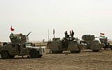 A Kurdish peshmerga convoy drives towards the front line in Khazer, about 30 kilometers (19 miles) east of Mosul, Iraq, Monday, Oct. 17, 2016. (AP Photo)