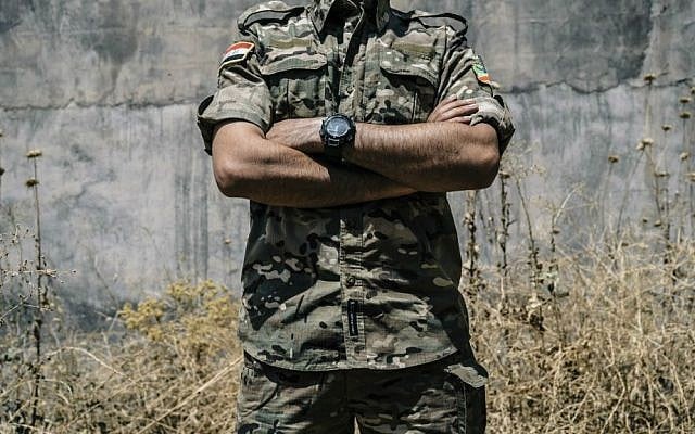 In this Aug. 10, 2016 file photo, Iraqi Army Cpl. Saif stands outside a building in Irbil, Iraq. (AP Photo/Alice Martins, File)