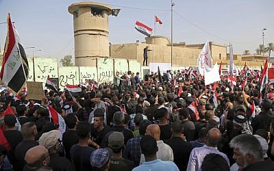 Supporters of Shiite cleric Muqtada al-Sadr wave national flags during a demonstration in front of the Turkish embassy calling for the immediate withdrawal of Turkish troops from northern Iraq, in Baghdad, Iraq, Tuesday, Oct. 18, 2016. (AP Photo/Karim Kadim)