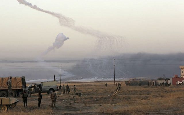 Smoke rises in nearby Mosul as Iraq's elite counterterrorism forces advance towards the city, Iraq, Thursday, Oct. 20, 2016. (AP Photo/Khalid Mohammed)