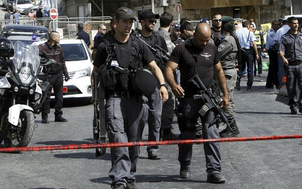 Israeli police secure the scene where a car driven by a Palestinian terrorist was intercepted by the police and the gunman shot dead in Jerusalem Sunday, Oct. 9, 2016. (AP Photo/Mahmoud Illean)