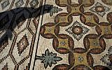 A laborer from the Palestinian Ministry of Tourism and Antiquities works at the site of a 7th century, 827 square meter (8900 square ft) mosaic ahead of the opening ceremony at the Islamic archaeological site of Hisham Palace, in the West Bank city of Jericho, Thursday, Oct. 20, 2016. (AP Photo/Nasser Nasser)