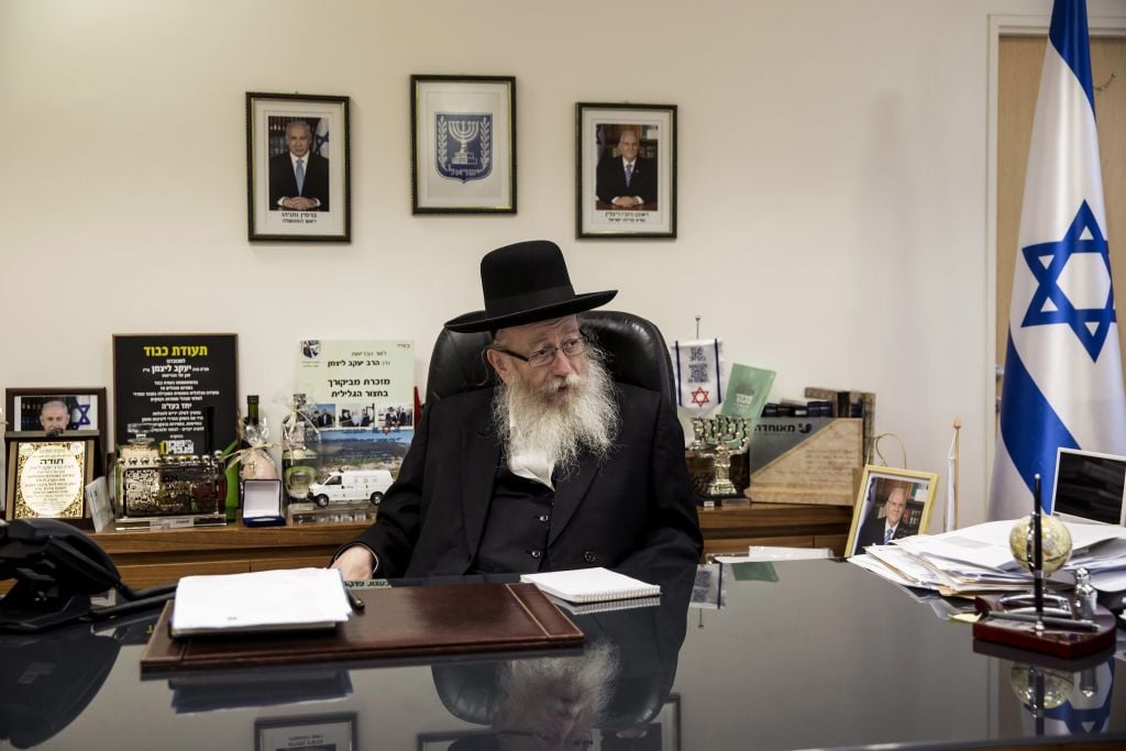 In this photo taken Wednesday, Sept. 7, 2016, Israeli Health Minister Yaakov Litzman speaks during an interview with the Associated Press in is office in Jerusalem. As the senior representative of ultra-Orthodox Jews in Israeli government, Health Minister Yaakov Litzman is unapologetic about the insular lifestyle he advocates and which has long irked mainstream Israel and endangered its long-term economic prospects. He insists that shirking military service, rejecting secular education and raising large families on state subsidies all serve the most noblest of purposes: a life devoted to the study of scripture that has preserved Jewish traditions over centuries and will ultimately bring about the coming of the Messiah. (AP Photo/Tsafrir Abayov) In this photo taken Wednesday, Sept. 7, 2016, Israeli Health Minister Yaakov Litzman speaks during an interview with the Associated Press in is office in Jerusalem. (AP Photo/Tsafrir Abayov)