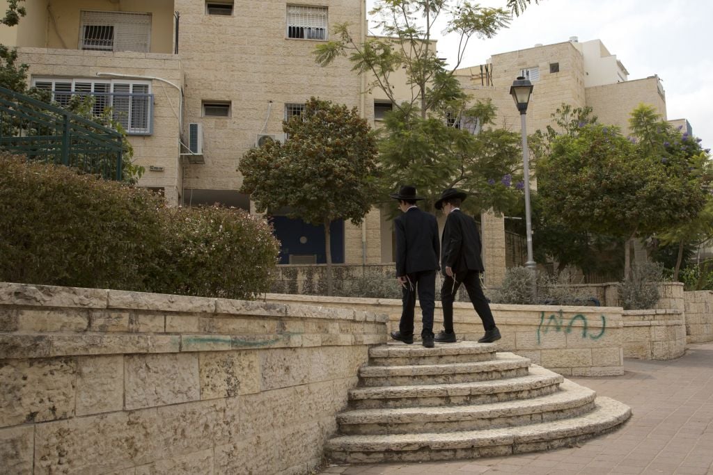 In this photo taken Tuesday, Aug. 30, 2016 ultra-Orthodox Jewish youths walk in the city of Elad, central Israel. (AP Photo/Sebastian Scheiner) In this photo taken Tuesday, Aug. 30, 2016 ultra-Orthodox Jewish youths walk in the city of Elad, central Israel. (AP Photo/Sebastian Scheiner)