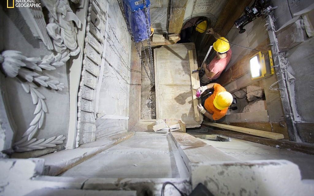 This Wednesday Oct. 26, 2016 photo shows the moment workers remove the top marble layer of the tomb said to be of Jesus, in the Church of Holy Sepulchre in Jerusalem. A restoration team has peeled away a marble layer for the first time in centuries in an effort to reach what it believes is the original rock surface where Jesus' body was laid. (Dusan Vranic/National Geographic via AP) This Wednesday Oct. 26, 2016 photo shows the moment workers remove the top marble layer of the tomb said to be of Jesus, in the Church of Holy Sepulchre in Jerusalem. A restoration team has peeled away a marble layer for the first time in centuries in an effort to reach what it believes is the original rock surface where Jesus' body was laid. (Dusan Vranic/National Geographic via AP)