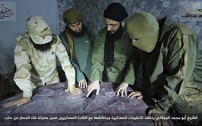 Abu Mohammed al-Golani (center) the leader of al-Qaeda linked insurgent group Fatah al-Sham Front, is seen in this picture posted by the group discussing battlefield details with field commanders. (Militant UGC via AP)
