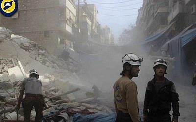 In this picture provided by the Syrian Civil Defense group known as the White Helmets, Syrian Civil Defense workers search through the rubble in rebel-held eastern Aleppo, Syria, Wednesday, Oct. 12, 2016. (Syrian Civil Defense- White Helmets via AP) 