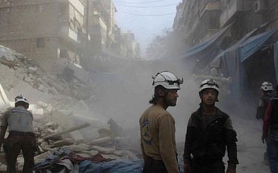 In this picture provided by the Syrian Civil Defense group known as the White Helmets, Syrian Civil Defense workers search through the rubble in rebel-held eastern Aleppo, Syria, Wednesday, October 12, 2016. (Syrian Civil Defense- White Helmets via AP)