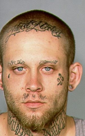 FILE--This 2013 booking file photo provided by the Las Vegas Metropolitan Police Department shows Bayzle Morgan. Morgan, who was allowed to use makeup to cover his neo-Nazi tattoos during his robbery trial and conviction in in August will not get to hide them during his upcoming murder trial punishable by the death penalty. (Las Vegas Metropolitan Police Department via AP, file)