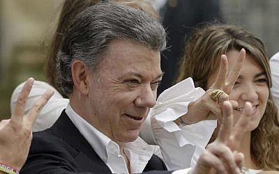 In this Sunday, Oct. 2, 2016 photo Colombia's President Juan Manuel Santos makes the victory sign after voting in a referendum to decide whether or not to support the peace deal he signed with rebels of the Revolutionary Armed Forces of Colombia, FARC, in Bogota, Colombia. Santos has won the Nobel Peace Prize, it was announced on Friday Oct. 7, 2016. (AP Photo/Ricardo Mazalan, File)