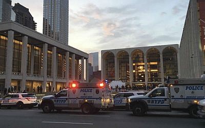 Police respond to New York's Metropolitan Opera which halted a performance after someone sprinkled an unknown powder into the orchestra pit, Saturday, Oct. 29, 2016. (Dylan Hayden via AP)