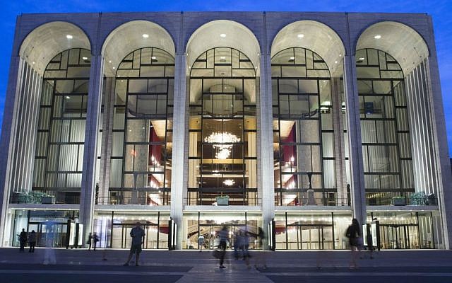 In this Aug. 1, 2014, file photo, pedestrians make their way in front of the Metropolitan Opera house at New York's Lincoln Center. (AP Poto/John Minchillo, File)