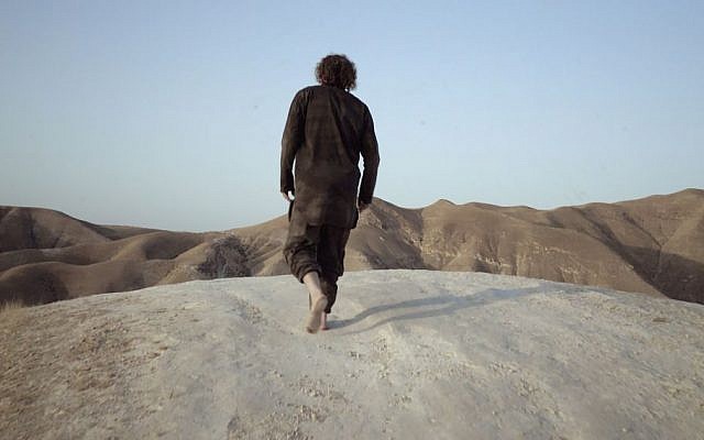 Theo Padnos, wearing the actual clothes he wore as a Nusra Front prisoner, walks in the Judaean Desert (standing in for Syria) during filming of 'Theo Who Lived.' (Zeitgeist Films) Theo Padnos, wearing the actual clothes he wore as a Nusra Front prisoner, walks in the Judaean Desert (standing in for Syria) during filming of 'Theo Who Lived.' (Zeitgeist Films)