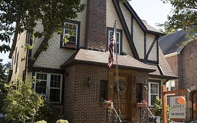 This Tuesday, Oct. 18, 2016 photo, shows the exterior of a house in the Jamaica Estates neighborhood of the Queens borough of New York, where Republican presidential candidate Donald Trump spent his early childhood.  (AP Photo/Mary Altaffer)