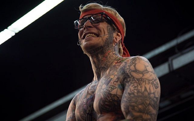 "Sideshow Rambo," a member of the Squidling Brothers "freak show," performs at the Israel Tattoo Convention. October 7, 2016. (Luke Tress/Times of Israel)