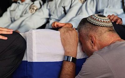 Uzi Kirma, father of First Sgt. Yosef Kirma, mourns alongside his son's coffin during the funeral on Jerusalem's Mount Herzl on October 9, 2016. Yosef Kirma, 29, was killed in a terror attack earlier that day. (Israel Police) Uzi Kirma, father of First Sgt. Yosef Kirma, mourns alongside his son's coffin during the funeral on Jerusalem's Mount Herzl on October 9, 2016. Yosef Kirma, 29, was killed in a terror attack earlier that day. (Israel Police)