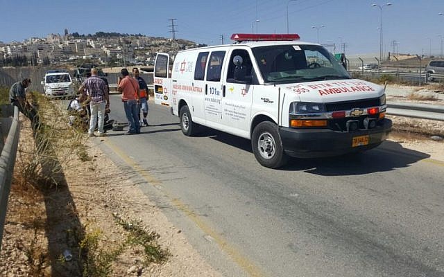 Illustrative: Medics from the Magen David Adom ambulance service treat an Israel Police officer and border guard that were injured when a car rammed through a checkpoint outside of Jerusalem on October 13, 2016. (Magen David Adom)