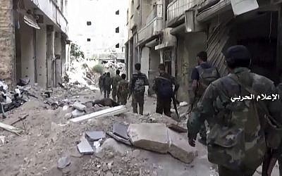 In this still image taken from video provided by the Syrian government-controlled Syrian Central Military Media, government troops patrol inside the Bustan Al-Basha neighborhood of Aleppo, Syria on Tuesday, Oct. 4, 2016. (Syrian Central Military Media via AP) In this still image taken from video provided by the Syrian government-controlled Syrian Central Military Media, government troops patrol inside the Bustan Al-Basha neighborhood of Aleppo, Syria on Tuesday, Oct. 4, 2016. (Syrian Central Military Media via AP)