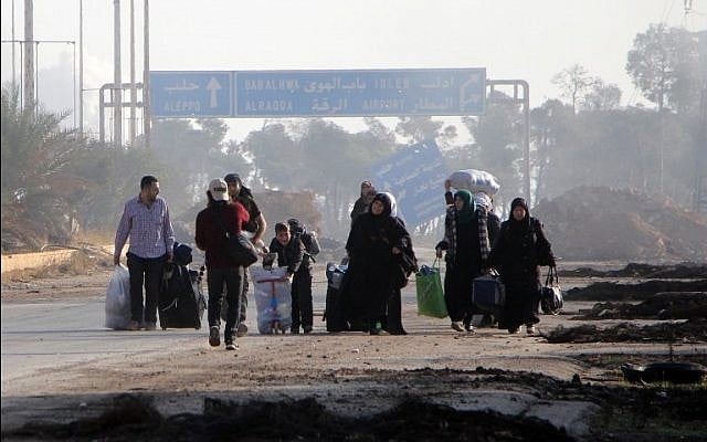 Syrians carry their belongings on October 30, 2016, as they leave Aleppo's southwestern frontline neighbourhood of Dahiyet al-Assad, on the third day of a rebel offensive to break a three-month regime siege on the opposition-held east of Syria's second city. AFP PHOTO / Omar haj kadour Syrians carry their belongings on October 30, 2016, as they leave Aleppo's southwestern frontline neighbourhood of Dahiyet al-Assad, on the third day of a rebel offensive to break a three-month regime siege on the opposition-held east of Syria's second city. AFP PHOTO / Omar haj kadour