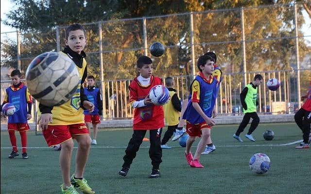 Jewish and Arab children in Jerusalem training together as part of the Kick It Out program to rid soccer of racism. (Yossi Zamir) Jewish and Arab children in Jerusalem training together as part of the Kick It Out program to rid soccer of racism. (Yossi Zamir)