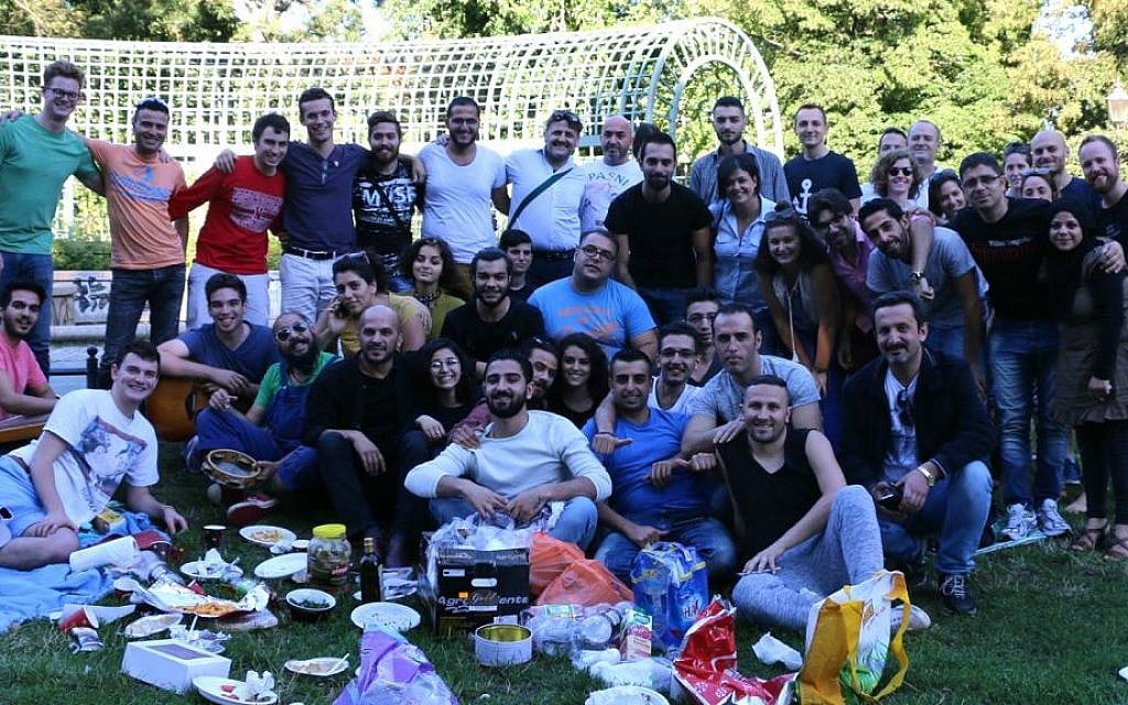 Middle Eastern refugees and IsraAID staff and volunteers at a picnic in a Berlin park, summer 2016. Hillel Zand is in the lower left corner. (Hillel Zand) Middle Eastern refugees and IsraAID staff and volunteers at a picnic in a Berlin park, summer 2016. Hillel Zand is in the lower left corner. (Hillel Zand)