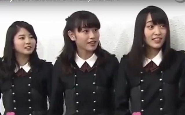 Members of Japanese girl band Keyakizaka46 wearing military-style costumes that were compared to Nazi uniforms. (screen capture: YouTube) Members of Japanese girl band Keyakizaka46 wearing military-style costumes that were compared to Nazi uniforms. (screen capture: YouTube)
