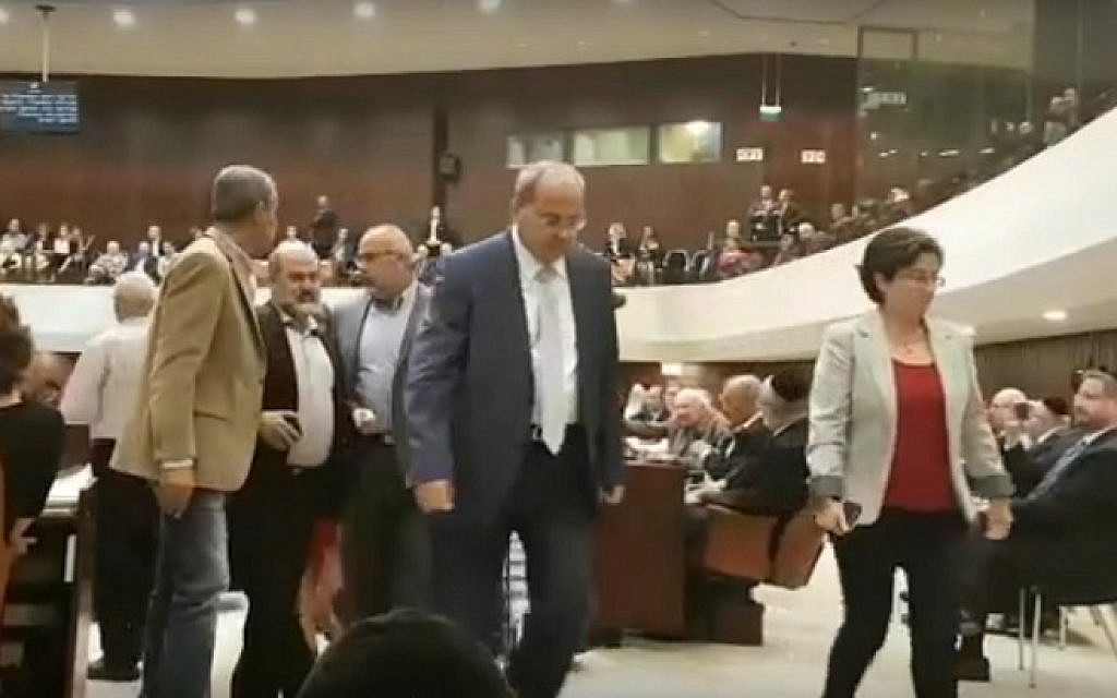 Hanin Zoabi (R) and Ahmad Tibi (C) join fellow Joint (Arab) List MKs as they walk out at the start of Prime Minister Benjamin Netanyahu's speech at the opening of the Knesset winter session on October 31, 2016 (screen capture: YouTube)