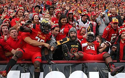 Some University of Maryland Terrapins players jumping into the stands before playing the Wisconsin Badgers at Byrd Stadium in College Park, Maryland, Nov. 7, 2015. (Patrick Smith/Getty Images via JTA)