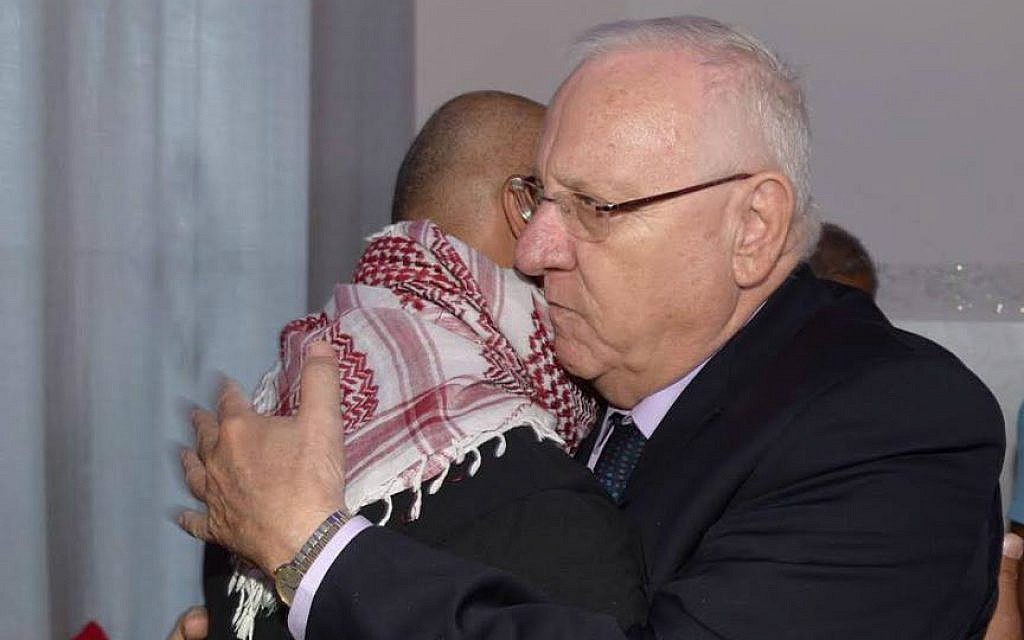 President Reuven Rivlin embraces Bassem Abu Amar, father of Nimer Bassem Abu Amar, 15, who was shot and killed by an Egyptian soldier on October 25, 2016. Rivlin visited the family at their home in Lakiya in southern Israel on October 27. (Mark Neyman/GPO)