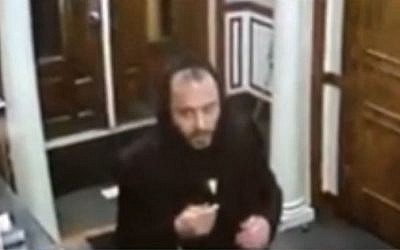 An unidentified man seen stealing four Torah scrolls from the  Avenue O Synagogue in Brooklyn, New York on October 25, 2016. (screen capture: