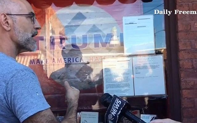 A screenshot from an interview with the owner of the Inquiring Minds Bookstore in upstate New York who displayed the name Trump superimposed over a Nazi flag. (screenshot: Daily Freeman) A screenshot from an interview with the owner of the Inquiring Minds Bookstore in upstate New York who displayed the name Trump superimposed over a Nazi flag. (screenshot: Daily Freeman)