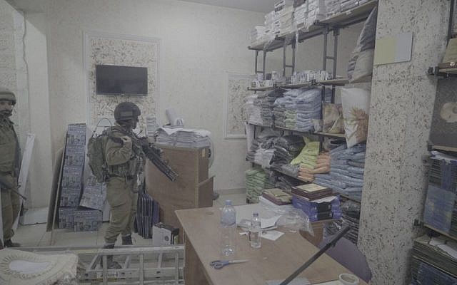 Soldiers inside a print shop which the IDF said produced posters and other material supporting terror attacks, in Al-Ram in the West Bank, October 19, 2016. (IDF Spokesperson) Soldiers inside a print shop which the IDF said produced posters and other material supporting terror attacks, in Al-Ram in the West Bank, October 19, 2016. (IDF Spokesperson)