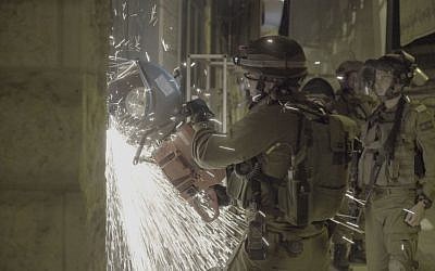 Soldiers breaking open a print shop which the IDF said produced posters and other material supporting terror attacks, in al-Ram in the West Bank, October 19, 2016. (IDF Spokesperson)