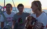 Women activists aboard the Zaytouna-Oliva sailboat headed for the Gaza Strip sing a song for Gaza. The boat was intercepted on October 5, 2016 by the Israeli Navy and escorted to the Israeli port of Ashdod. (Screenshot)